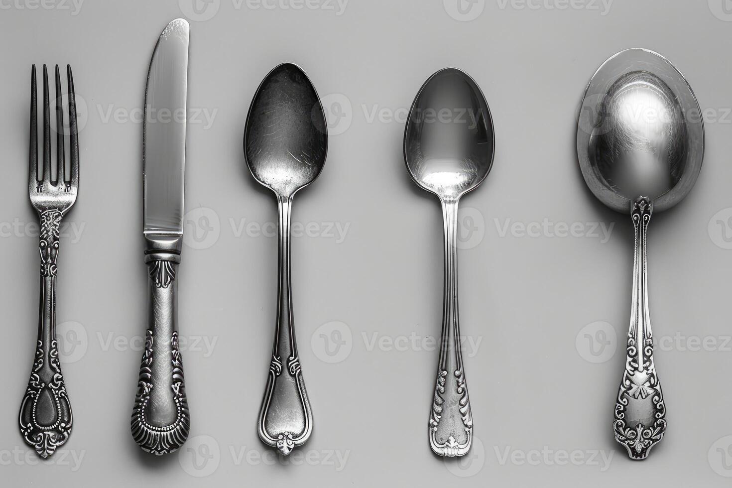 Ornate Silverware Set on a Grey Background photo