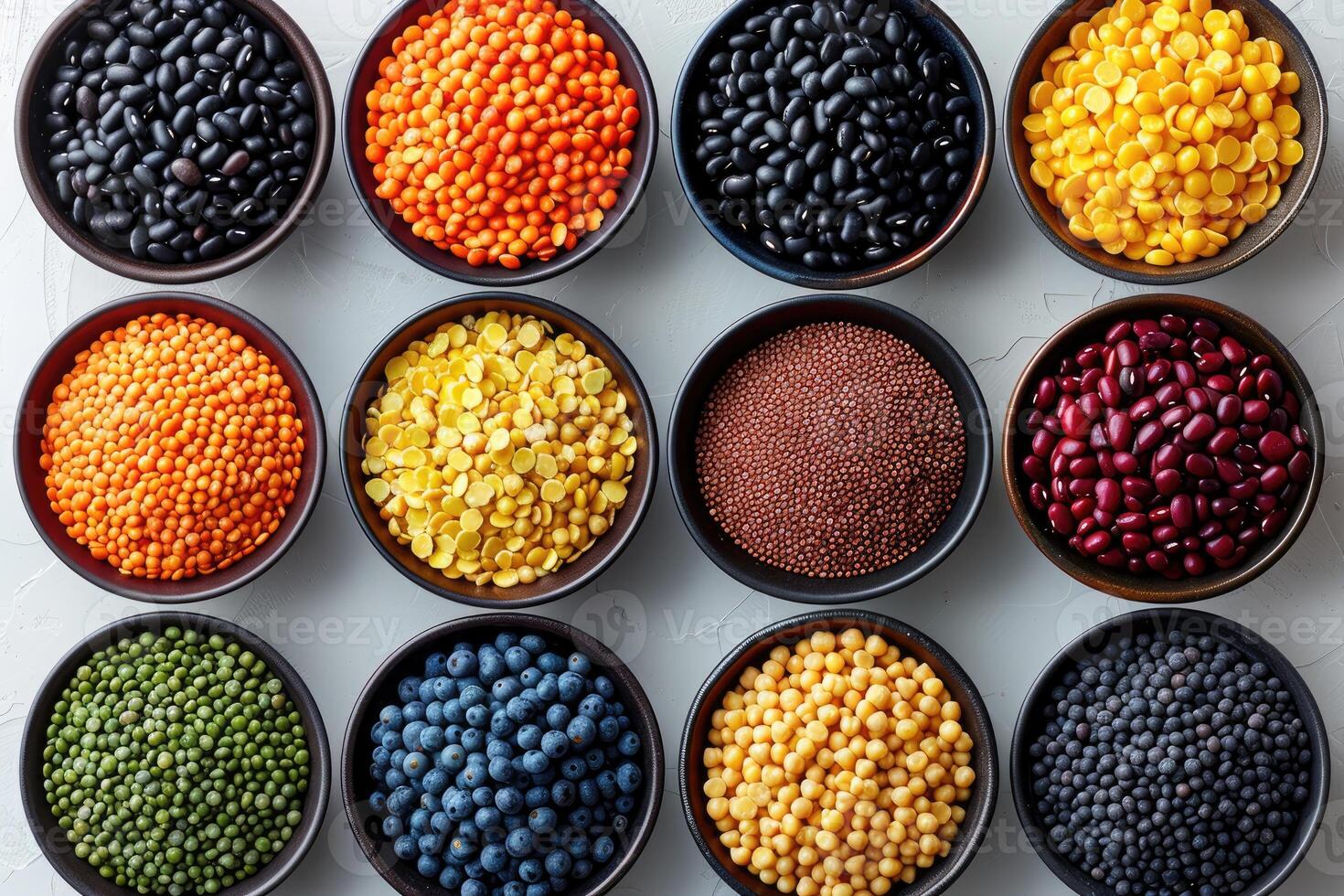 Colorful variety of beans lentils and peas in bowls on a white background photo