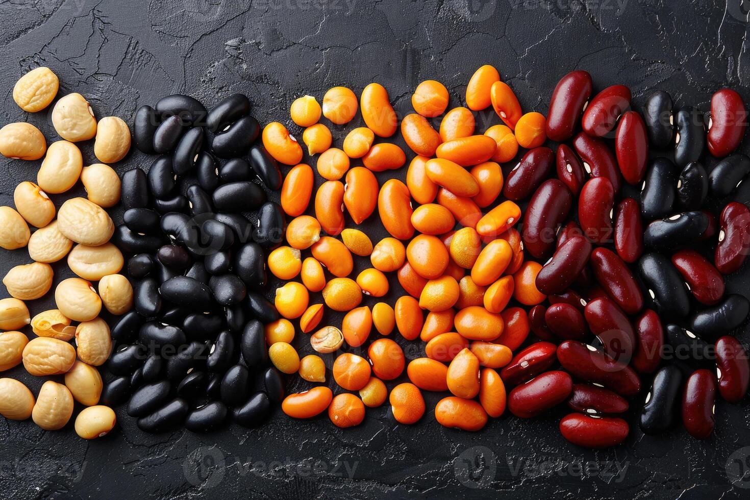 Various colorful dried beans and lentils on a dark background photo
