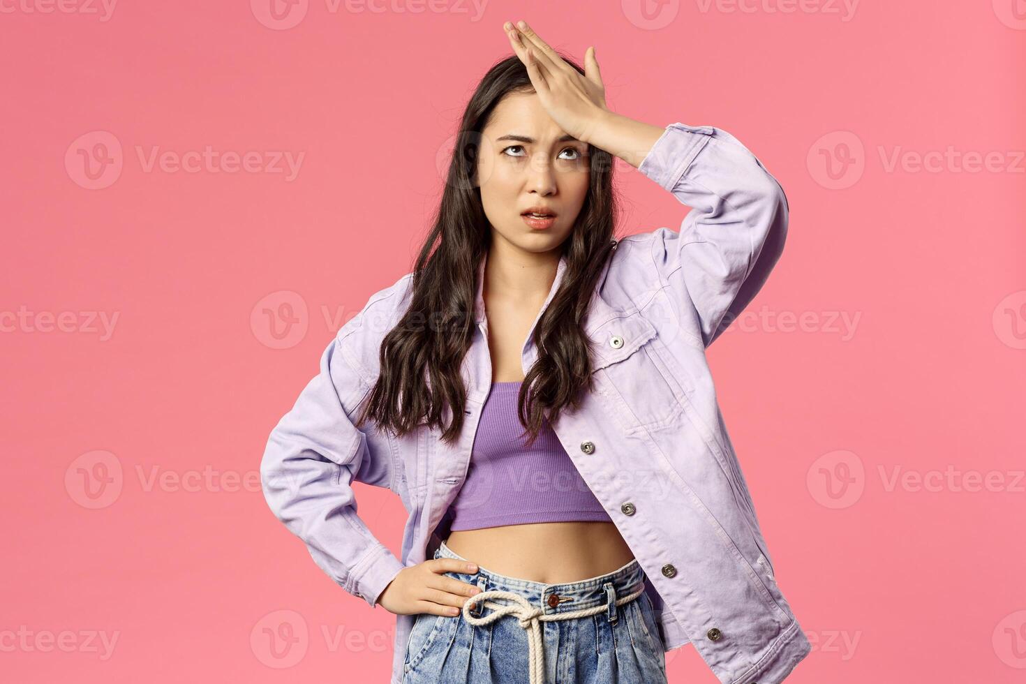 Portrait of sick and tired, annoyed young stylish girl taking care of new employee, facepalm, do eye roll and punch forehead sighing bothered, have lots of troubles, stand pink background photo