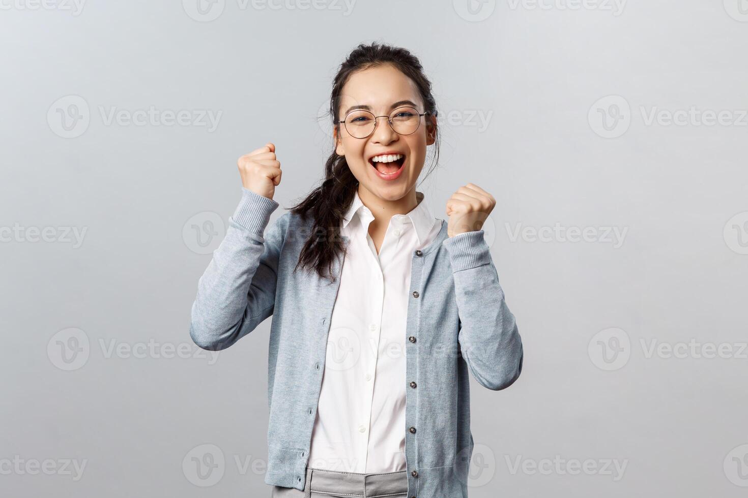 Super cool news, good for you. Optimistic, supportive asian girl encourage friend, watching sports game and rooting for team, chanting and smiling, triumphing from success, celebrate victory photo