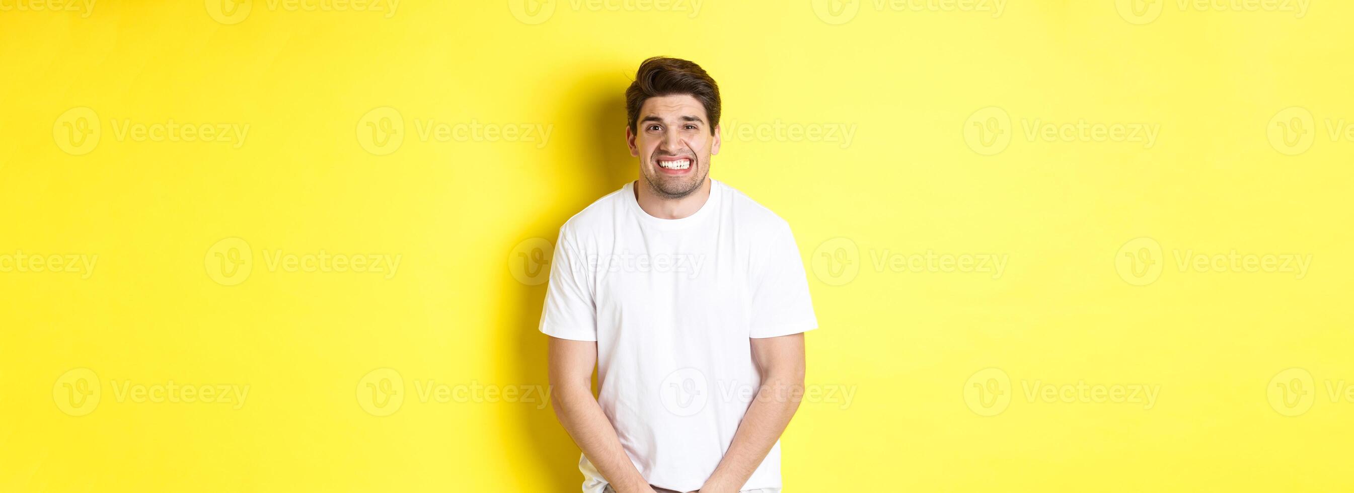 Bladder problem. Man need to toilet, holding hands on crotch and grimacing, urinal dysfunction. Copy space photo