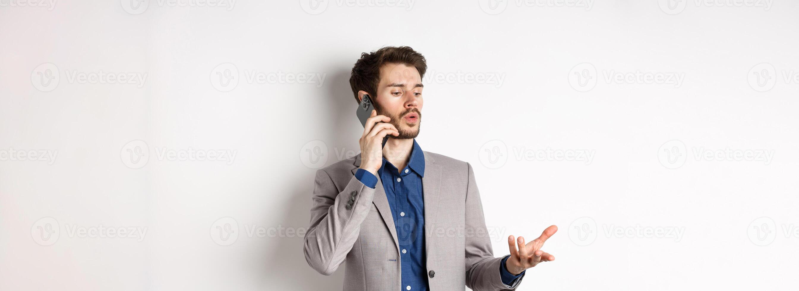 Handsome businessman having business call on phone, gesturing while talking on mobile, having conversation, white background photo