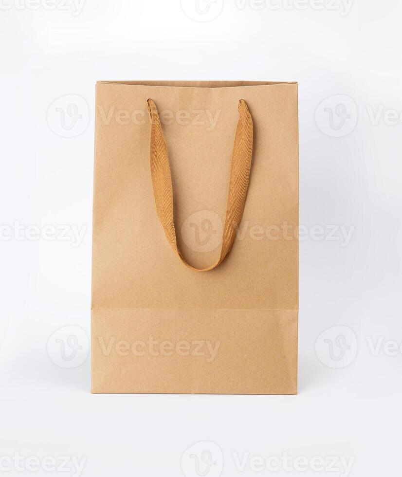 Folded paper bag with handle isolated on white background photo
