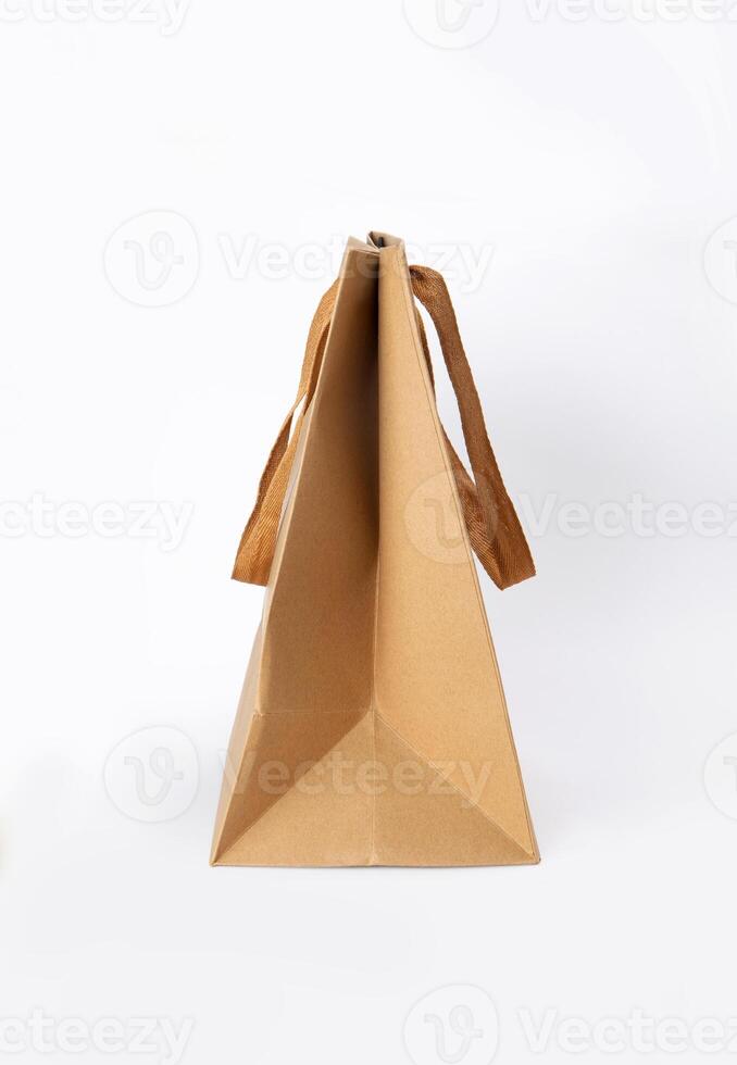 Folded paper bag with handle isolated on white background photo