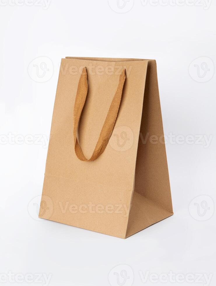 Folded paper bag with handle isolated on white background photo