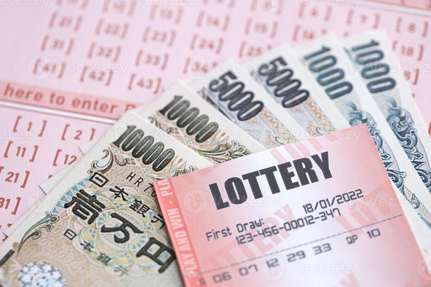 Lottery tickets lies with japanese yen bills on gambling sheets with numbers for marking to play lottery photo