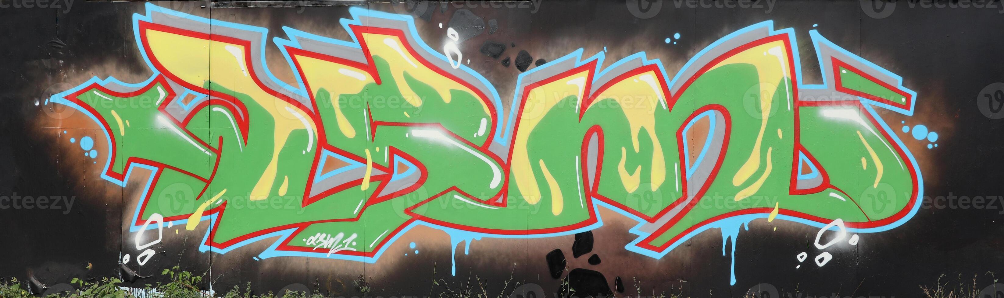 Colorful background of graffiti painting artwork with bright aerosol outlines on wall. Old school street art piece made with aerosol spray paint cans. Contemporary youth culture photo