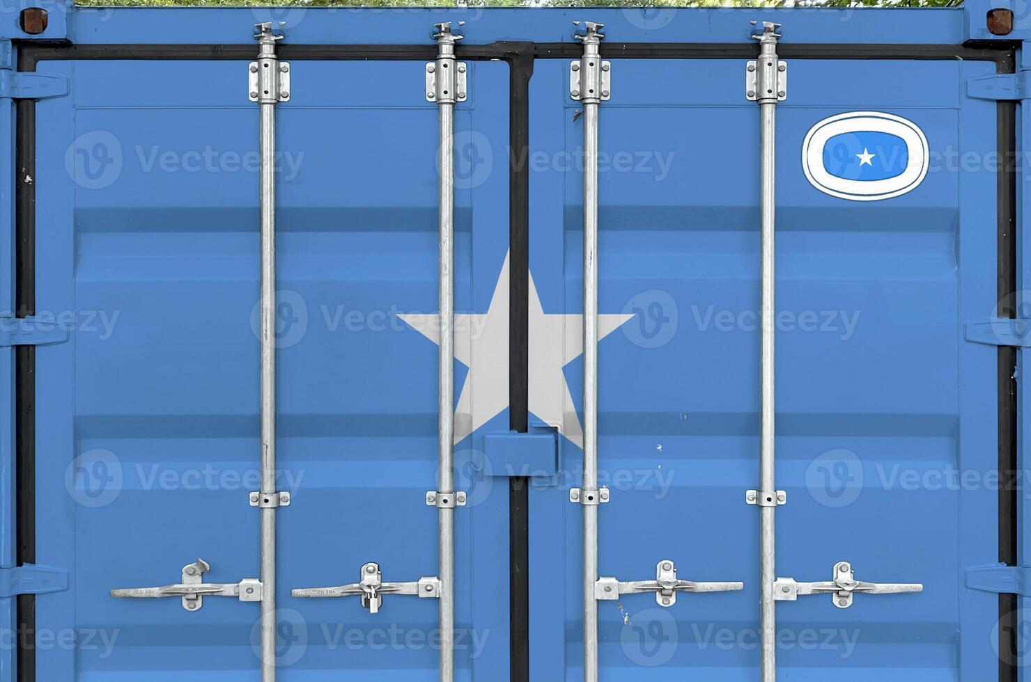 Somalia flag depicted on metal doors of shipping cargo container outdoors in docks area photo