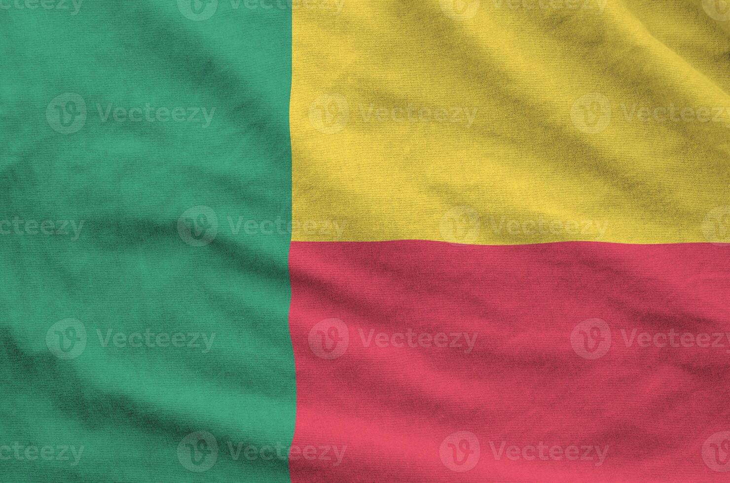 Benin flag depicted on folded wavy fabric of old cloth photo