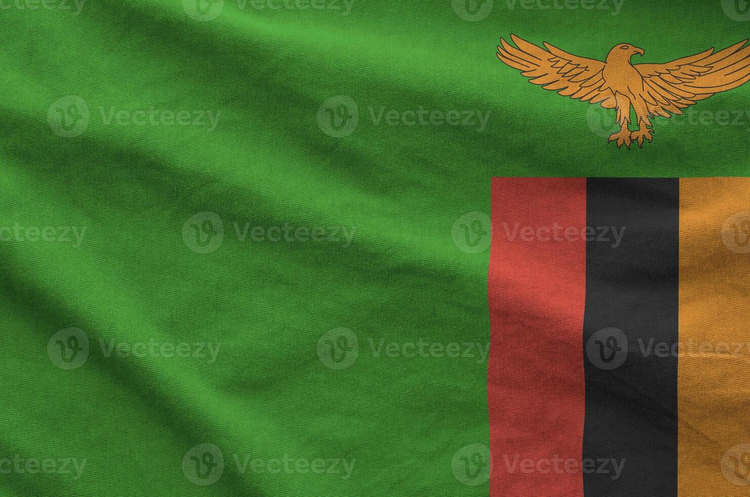 Zambia flag depicted on folded wavy fabric of old cloth photo