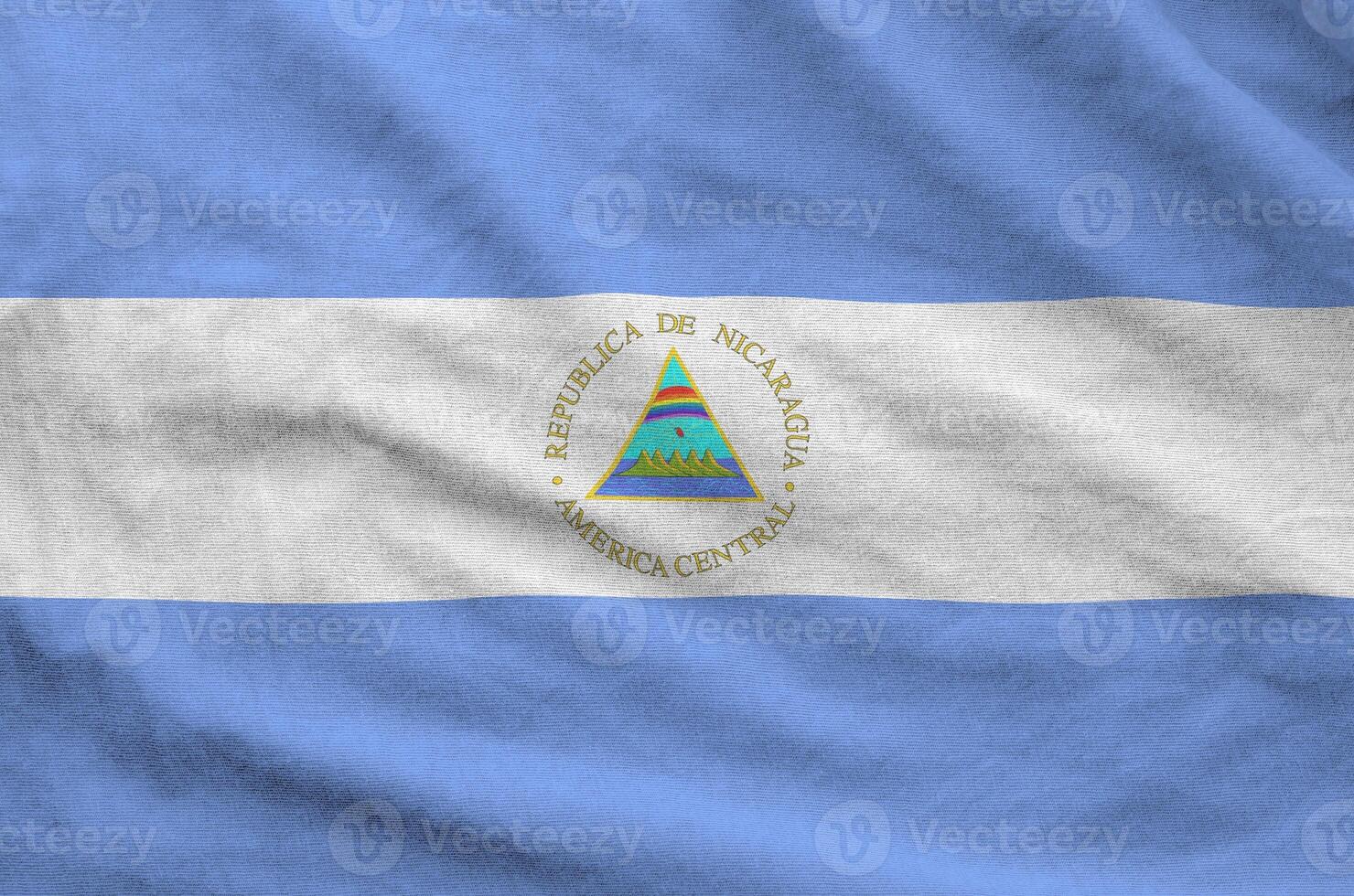 Nicaragua flag depicted on folded wavy fabric of old cloth photo