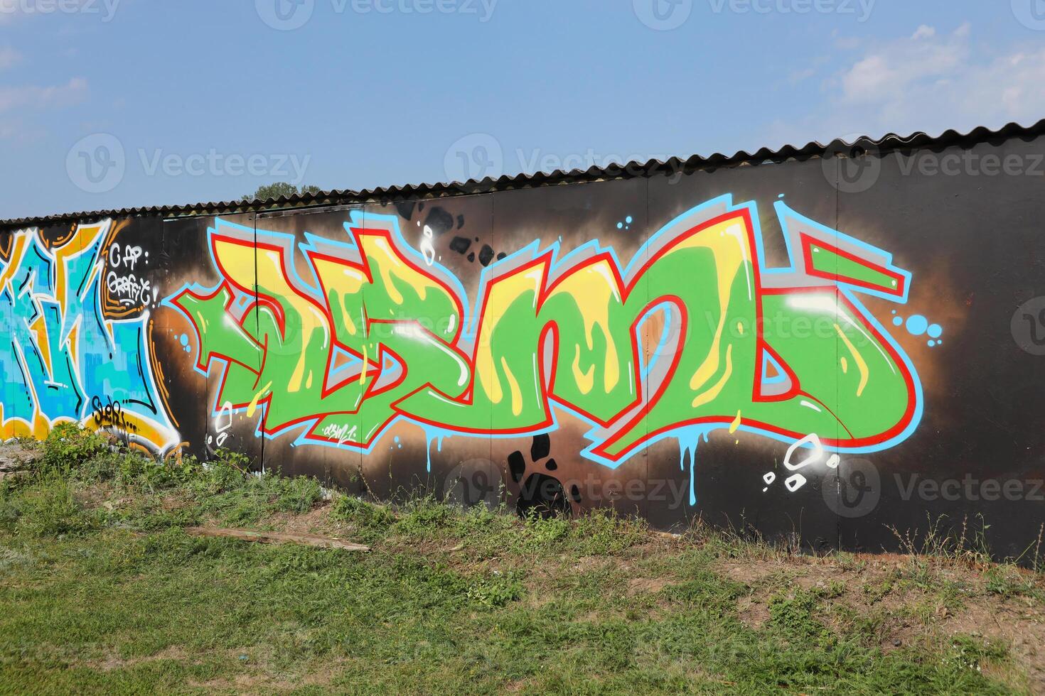 Colorful background of graffiti painting artwork with bright aerosol outlines on wall. Old school street art piece made with aerosol spray paint cans. Contemporary youth culture photo