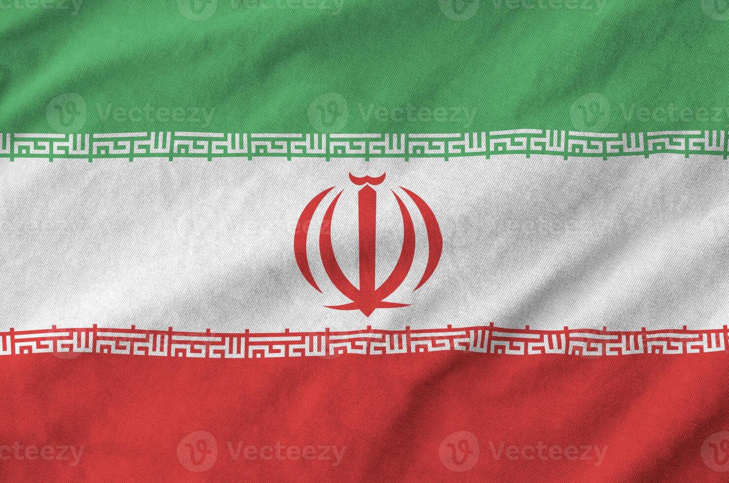 Iran flag depicted on folded wavy fabric of old cloth photo
