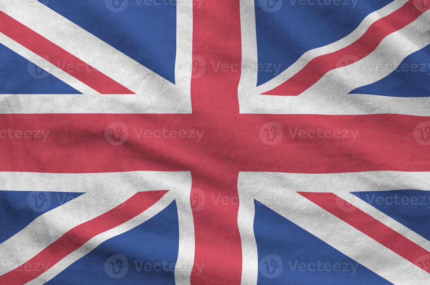 Great britain flag depicted on folded wavy fabric of old cloth photo