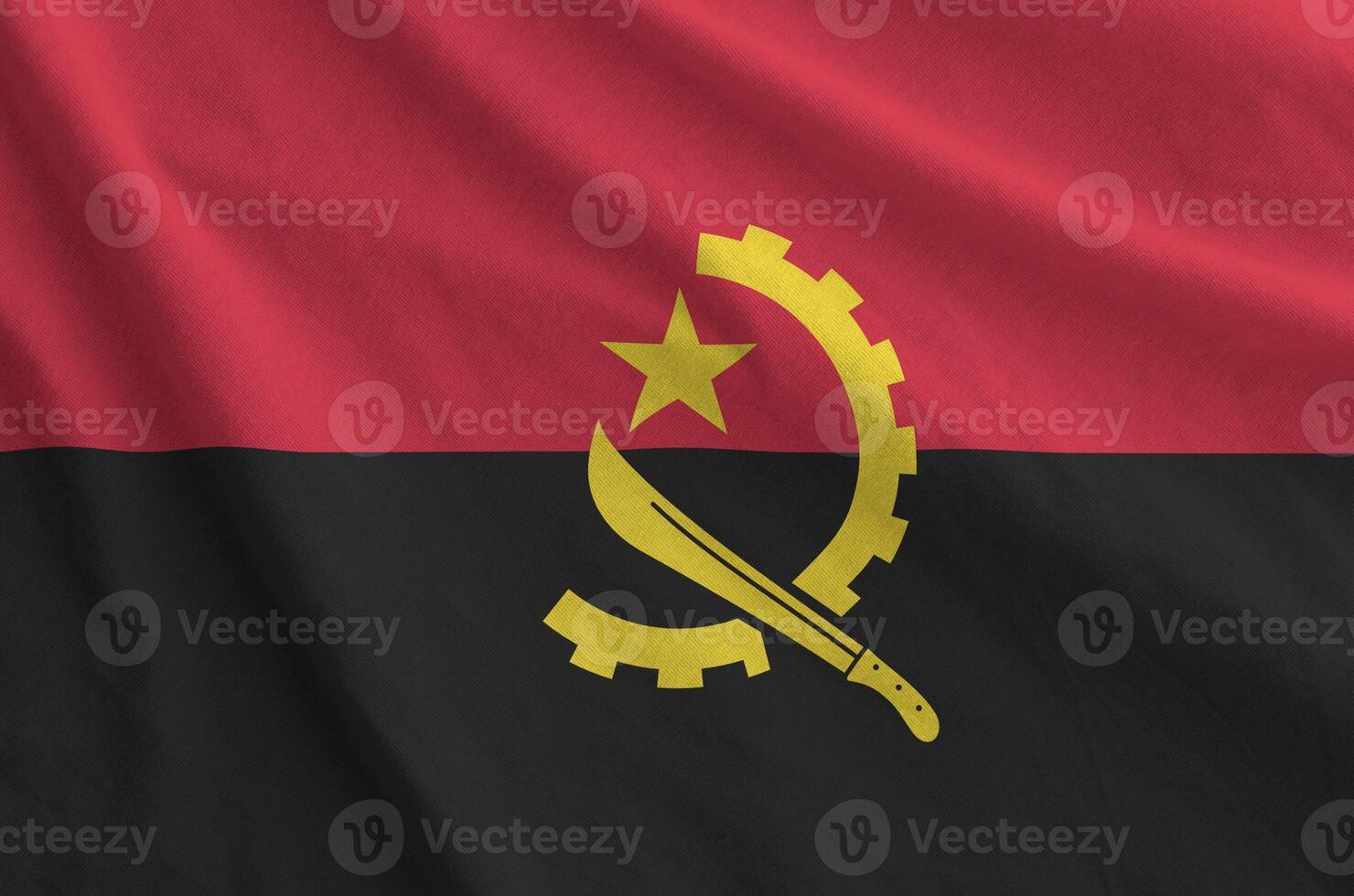 Angola flag depicted on folded wavy fabric of old cloth photo