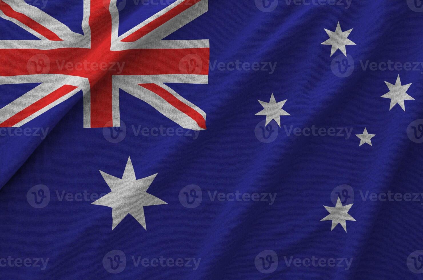 Australia flag depicted on folded wavy fabric of old cloth photo