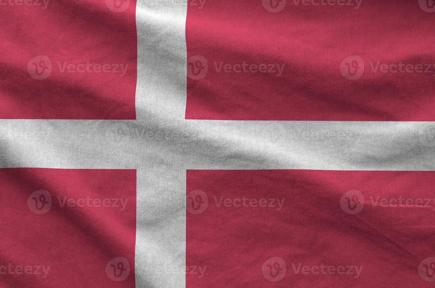 Denmark flag depicted on folded wavy fabric of old cloth photo