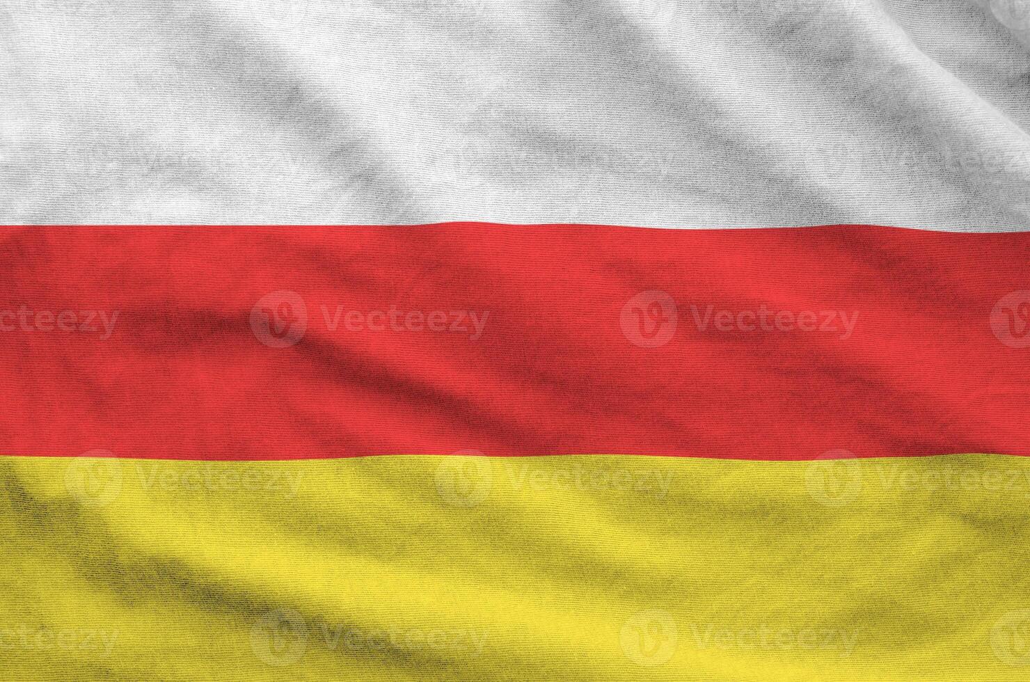 South Ossetia flag depicted on folded wavy fabric of old cloth photo