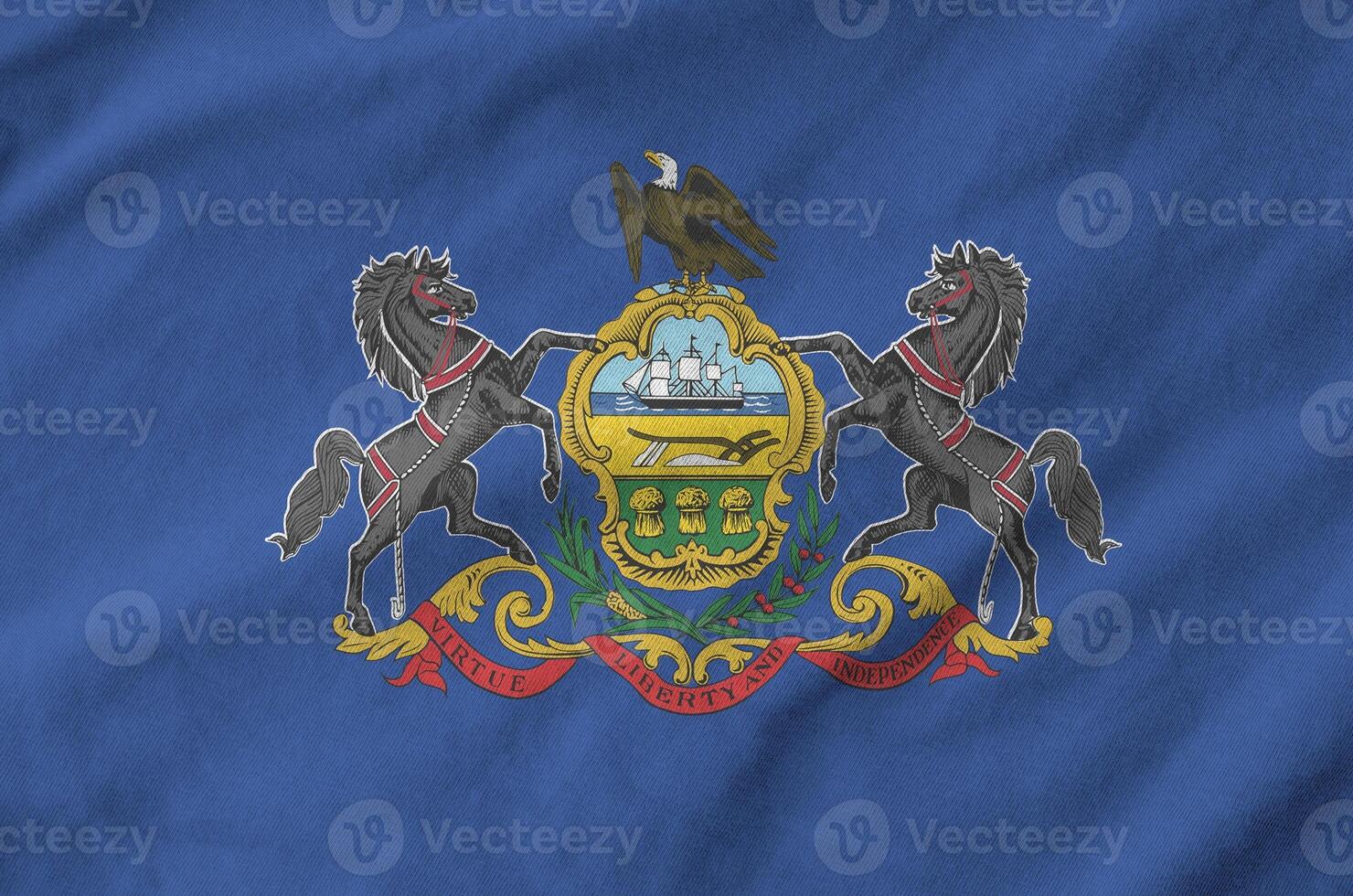 Pennsylvania US state flag depicted on folded wavy fabric of old cloth photo