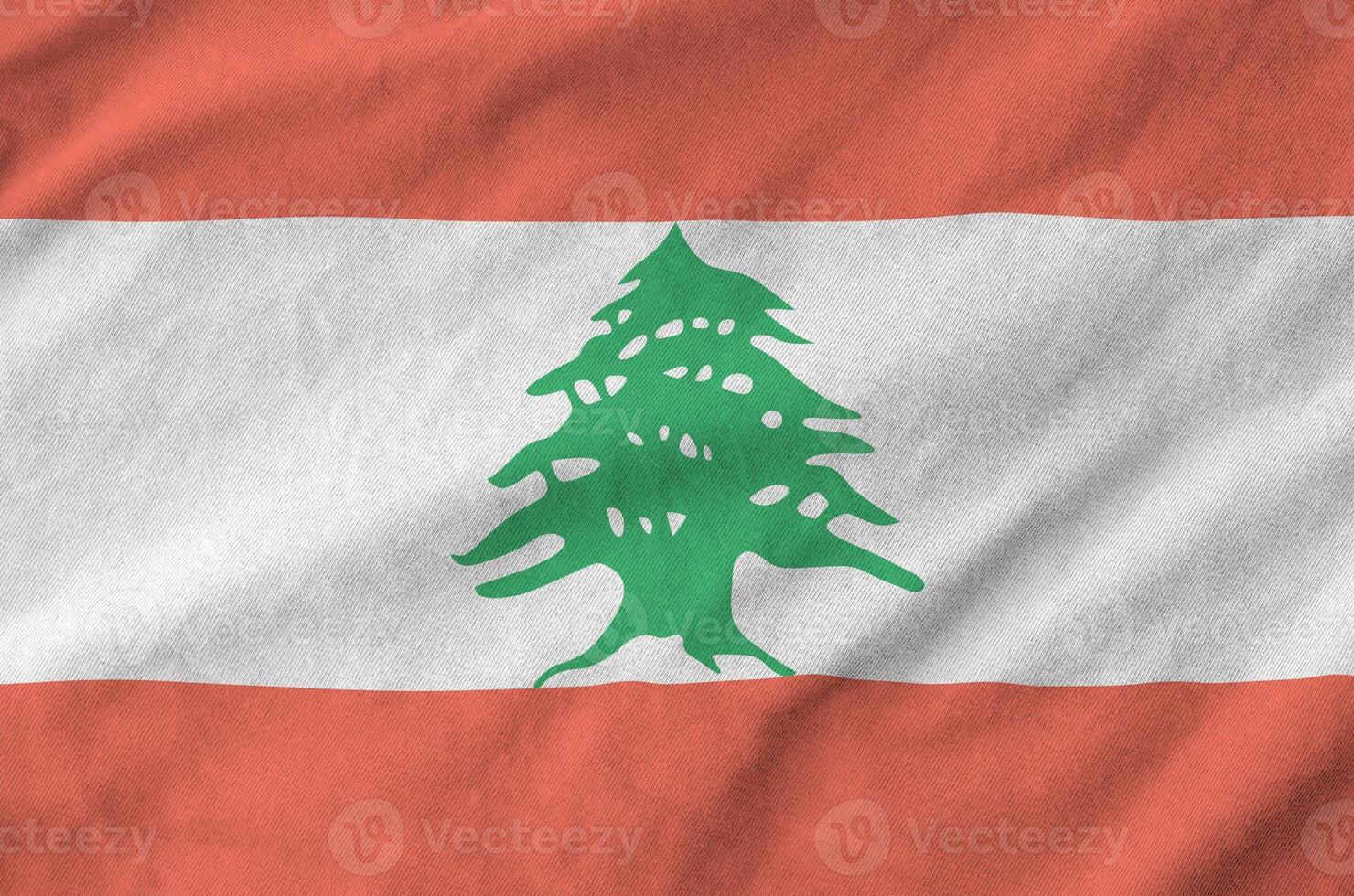 Lebanon flag depicted on folded wavy fabric of old cloth photo