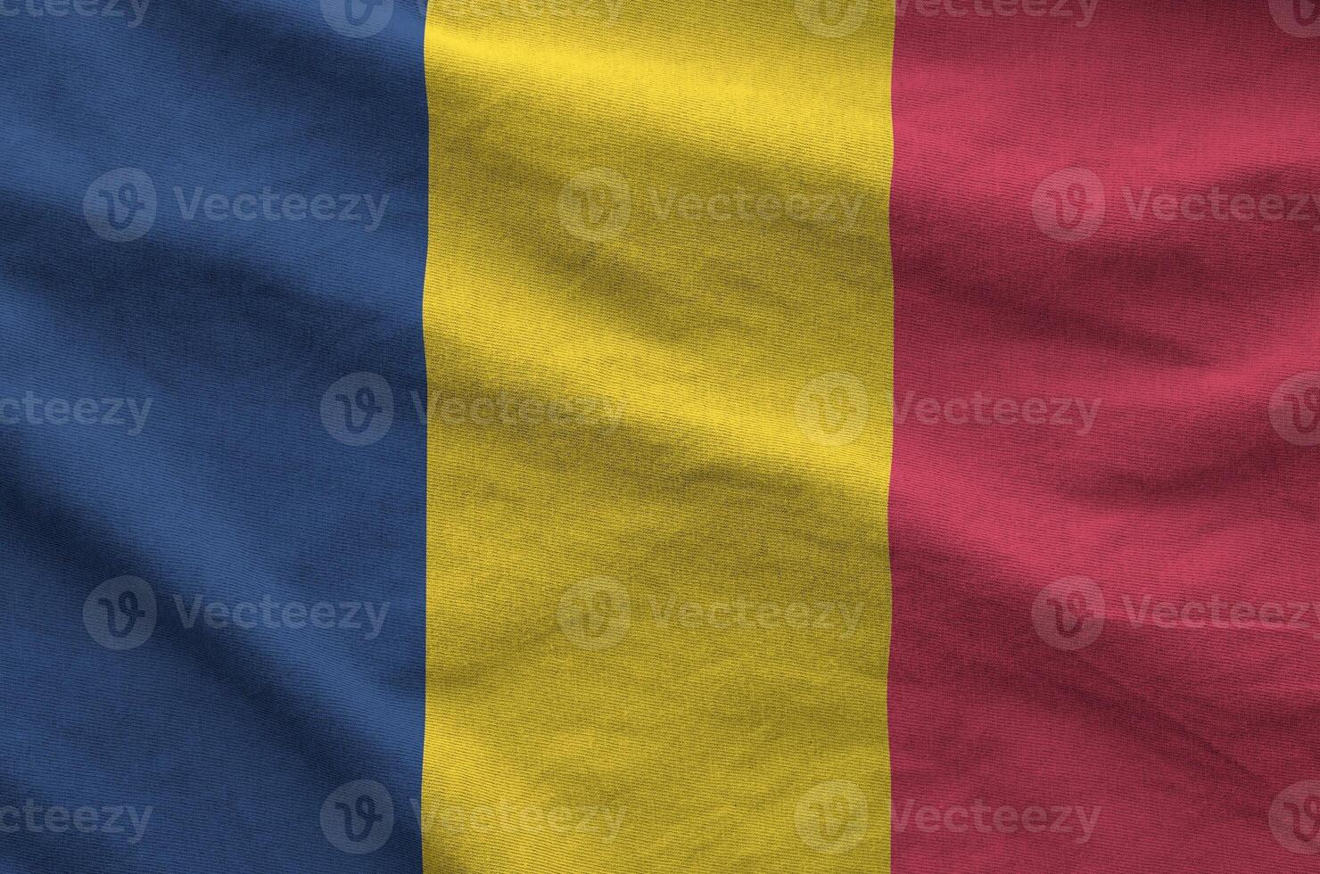 Chad flag depicted on folded wavy fabric of old cloth photo