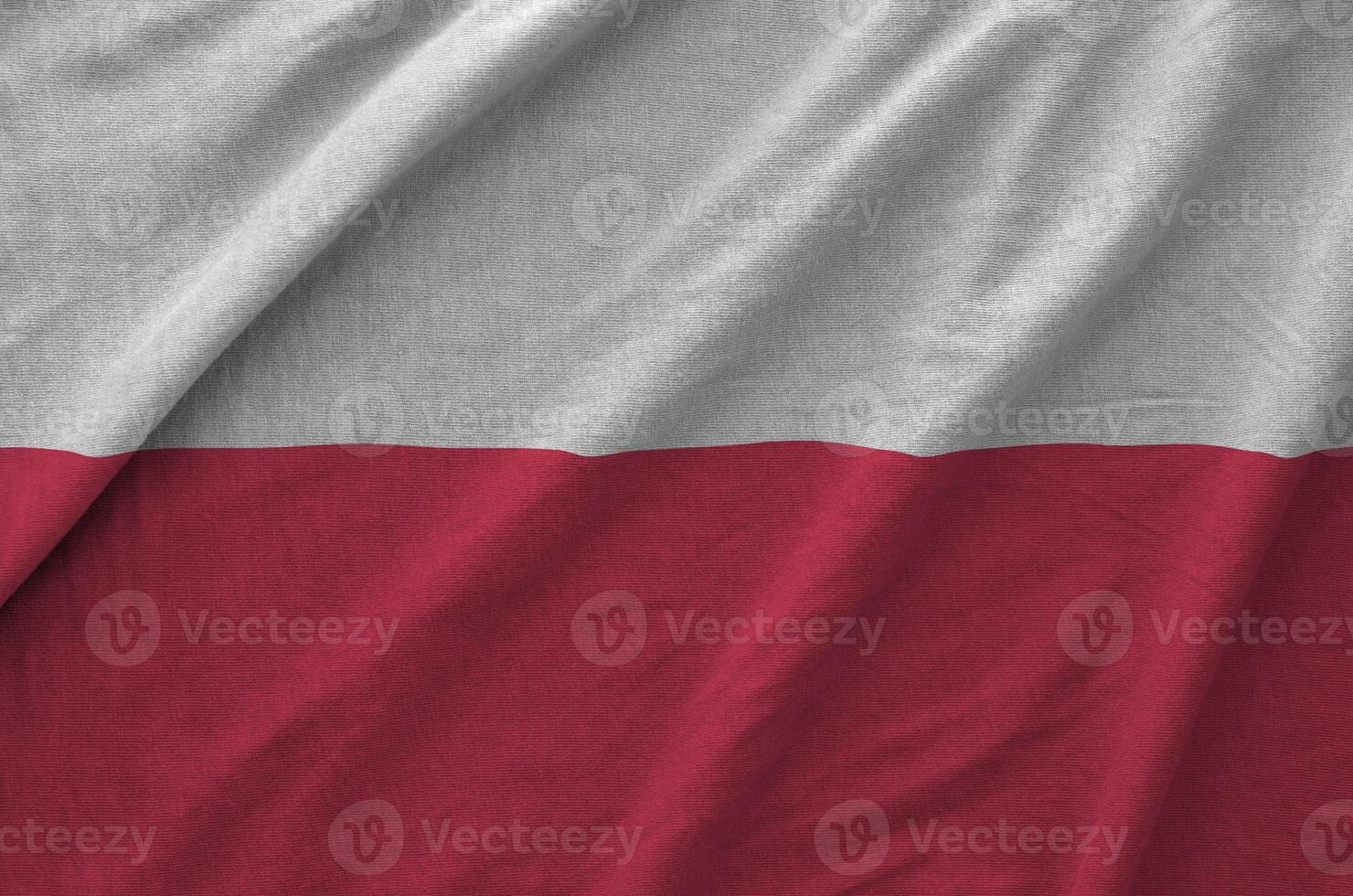 Poland flag depicted on folded wavy fabric of old cloth photo