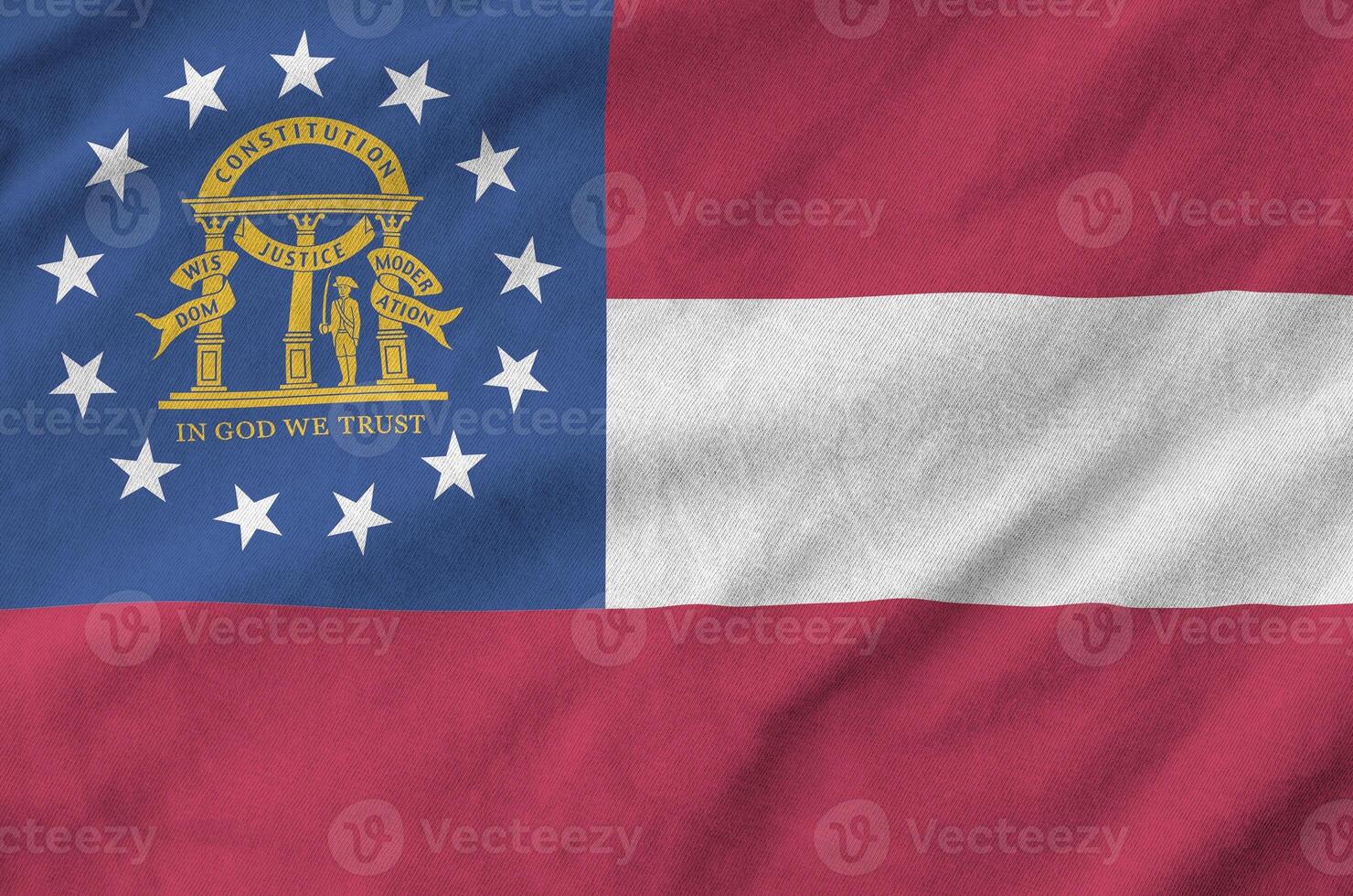 Georgia US state flag depicted on folded wavy fabric of old cloth photo