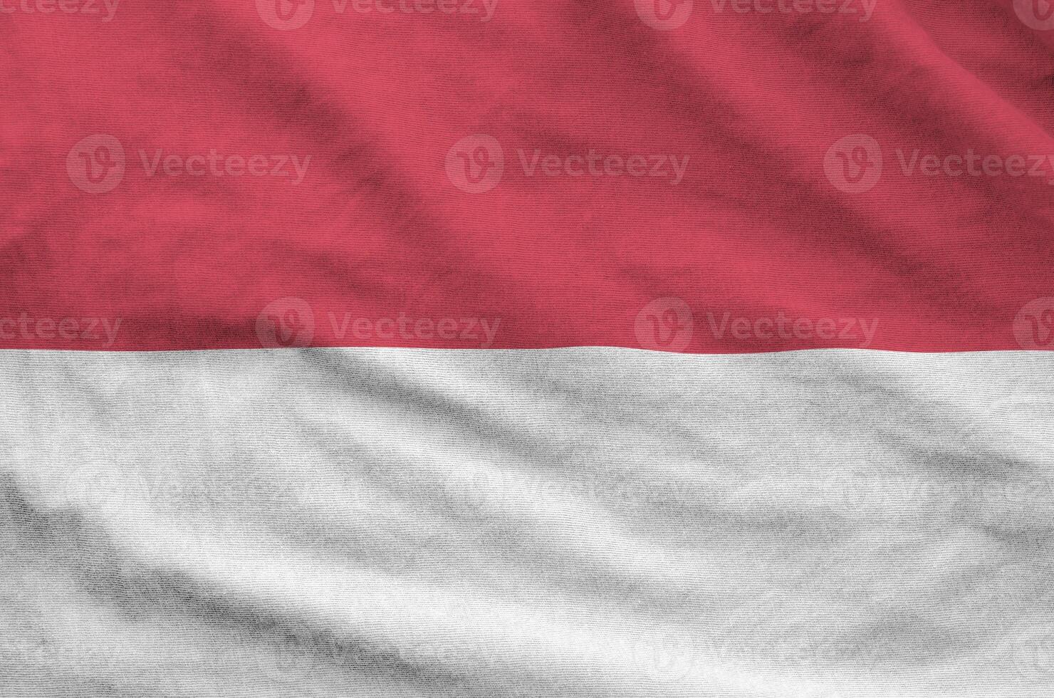 Indonesia flag depicted on folded wavy fabric of old cloth photo