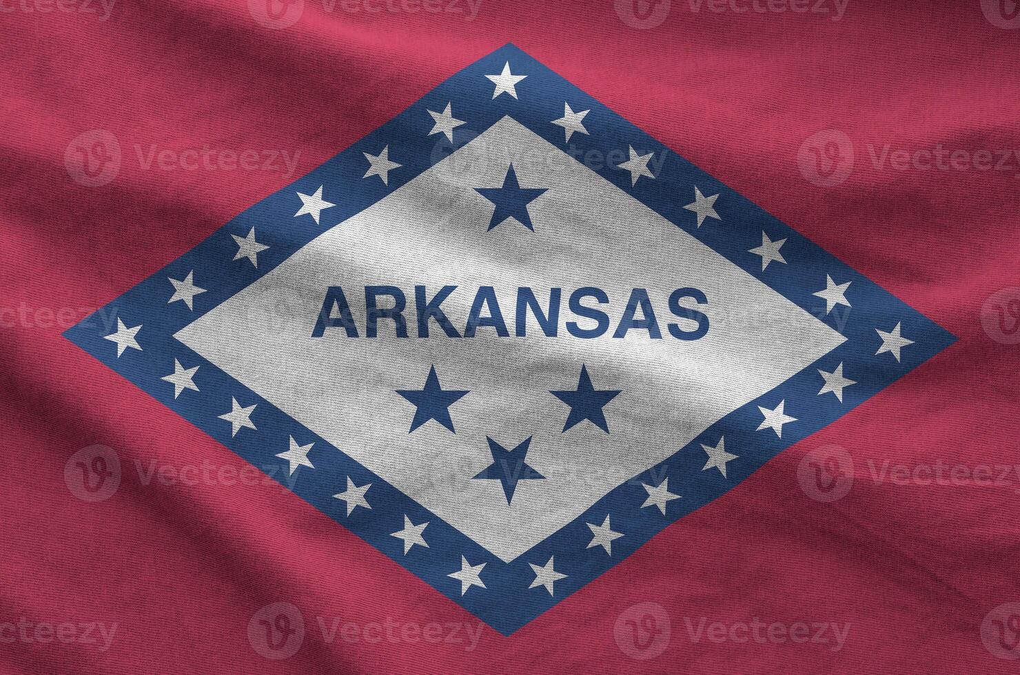 Arkansas US state flag depicted on folded wavy fabric of old cloth photo