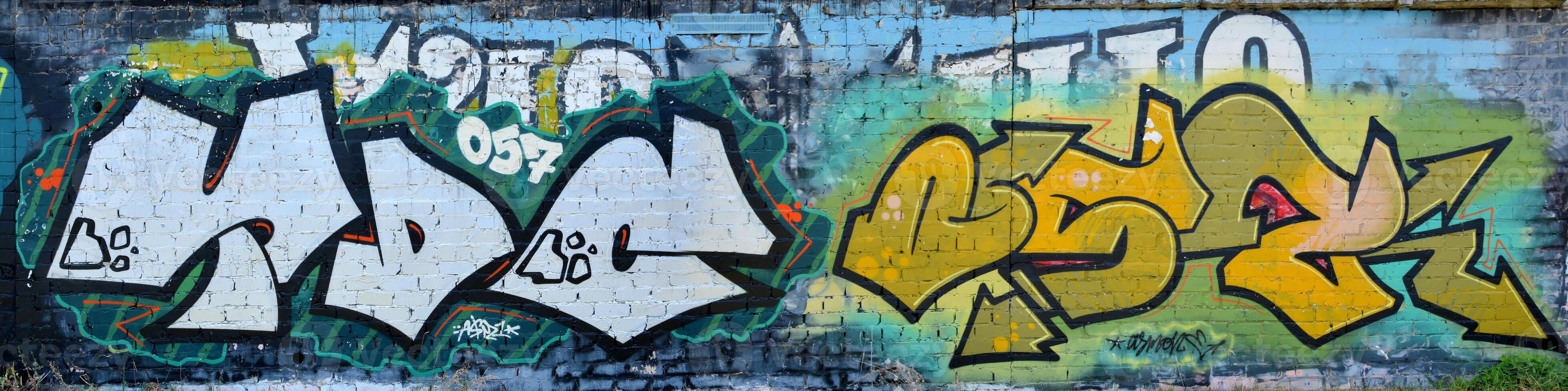 Colorful background of graffiti painting artwork with bright aerosol outlines on wall. Old school street art piece made with aerosol spray paint cans. Contemporary youth culture photo