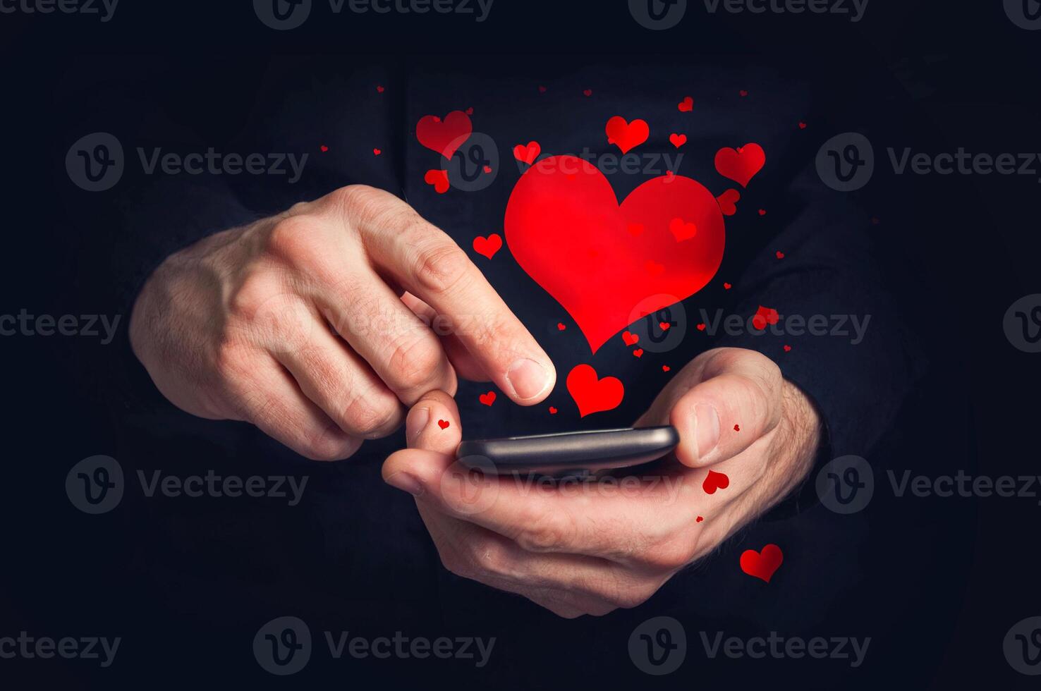 Man typing love text messages on a smartphone for Valentine's day photo