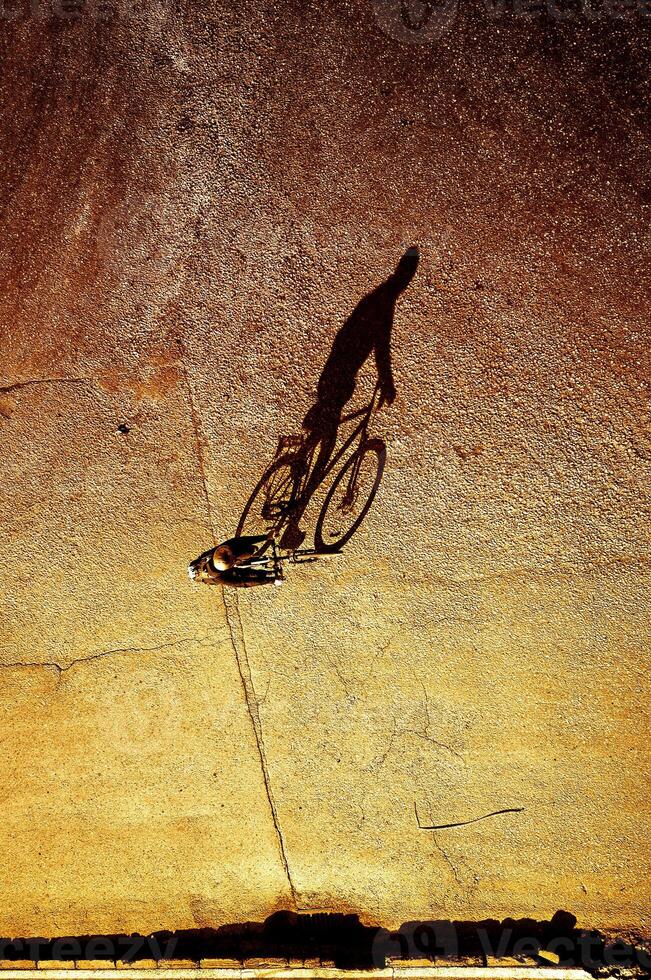 Shadow of a biker on the road photo