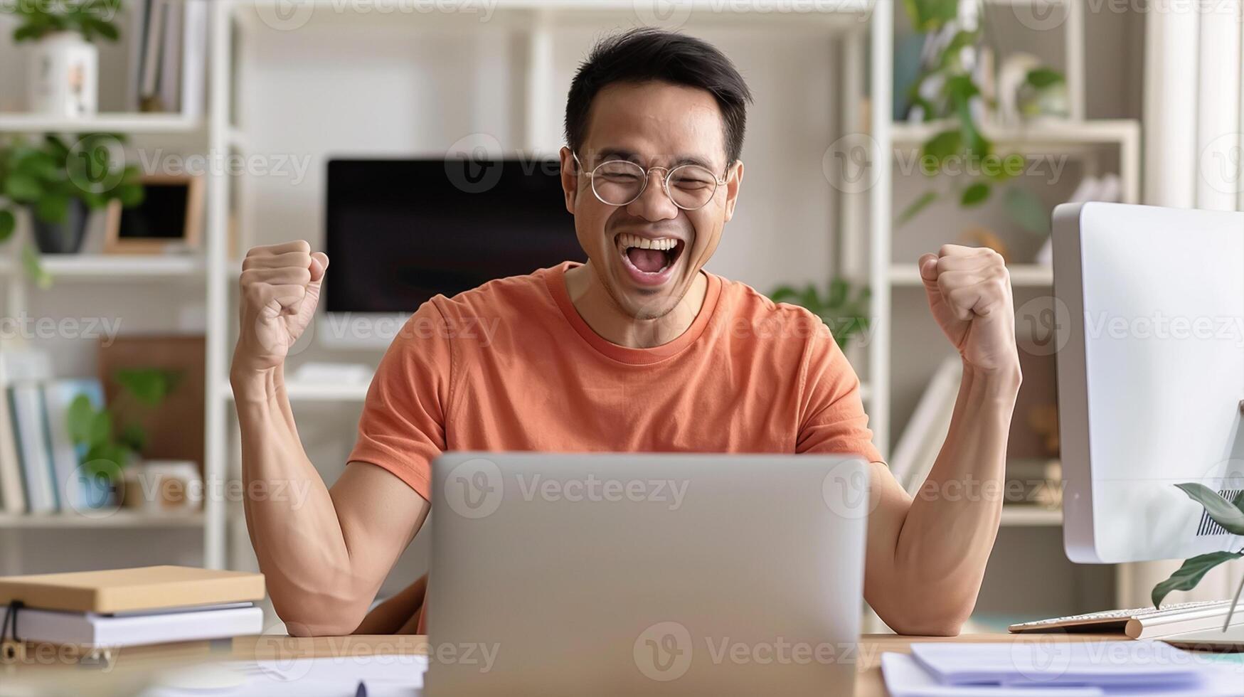 Excited Asian man sit at desk feel euphoric win online lottery, happy asian man overjoyed get mail at laptop being promoted at work photo