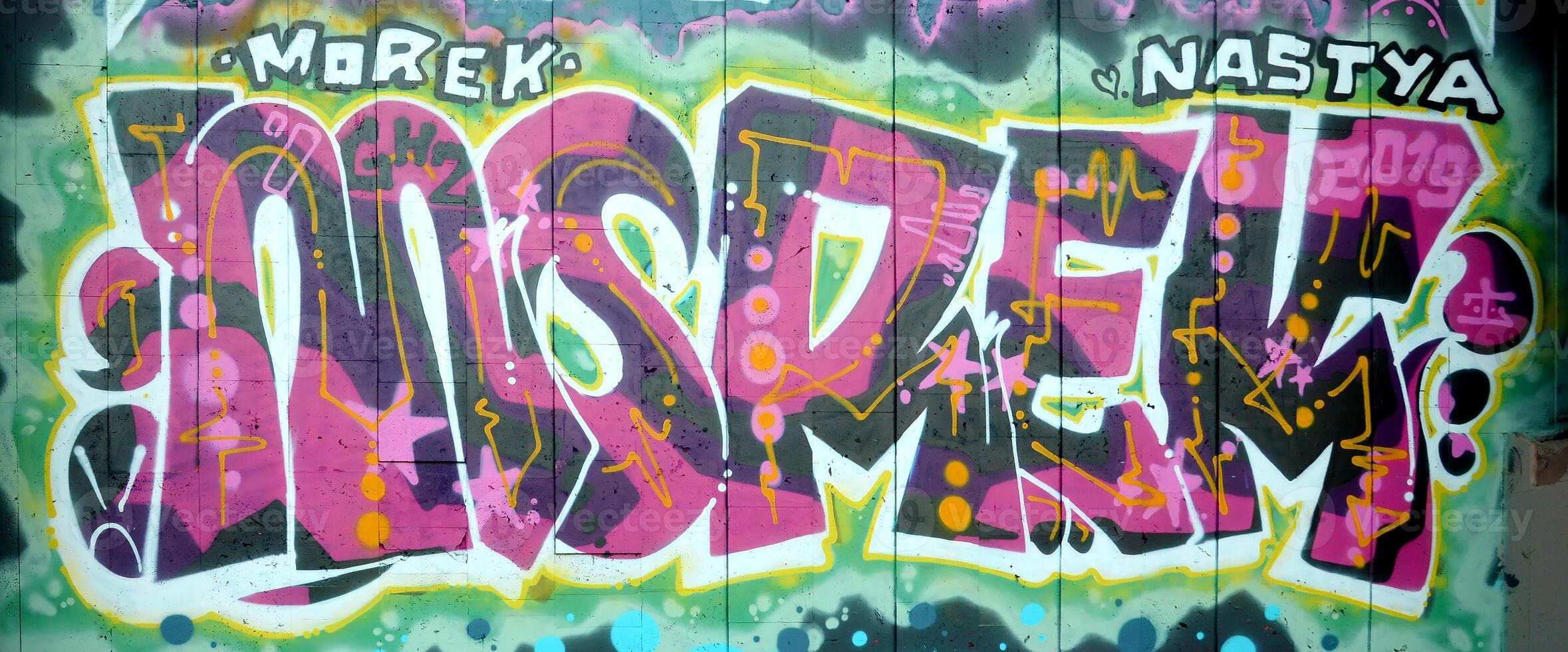 Colorful background of graffiti painting artwork with bright aerosol outlines on wall. Old school street art piece made with aerosol spray paint cans. Contemporary youth culture photo