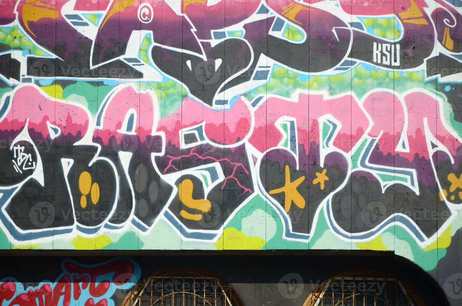 Colorful background of graffiti painting artwork with bright aerosol outlines on wall. Old school street art piece made with aerosol spray paint cans. Contemporary youth culture photo