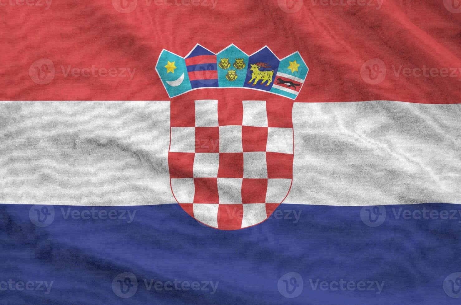 Croatia flag depicted on folded wavy fabric of old cloth photo