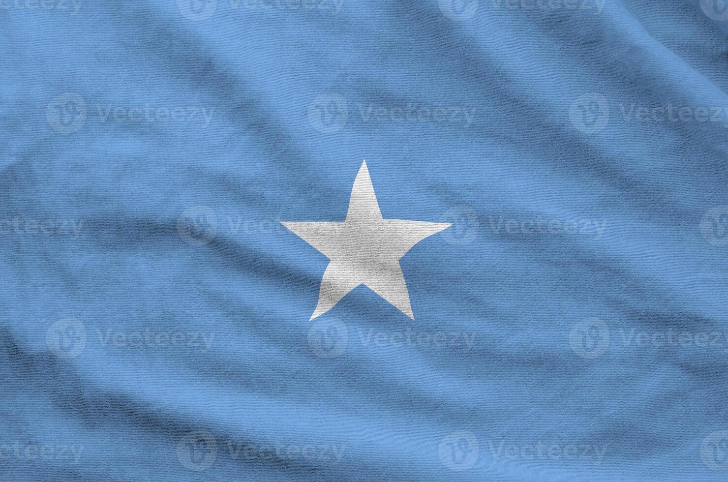 Somalia flag depicted on folded wavy fabric of old cloth photo