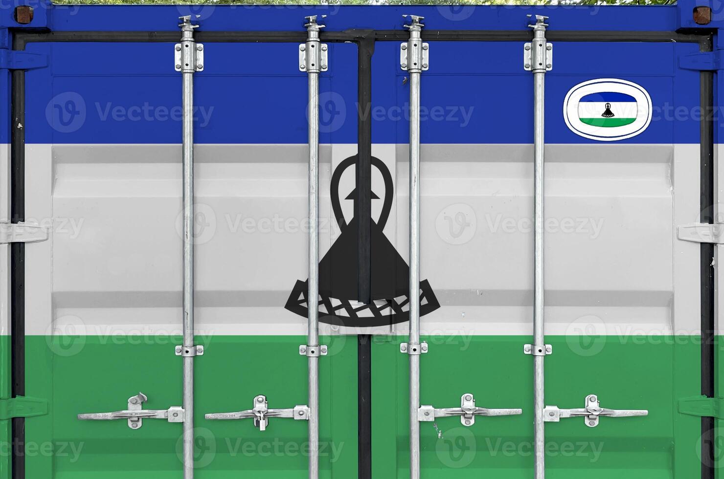 Lesotho flag depicted on metal doors of shipping cargo container outdoors in docks area photo