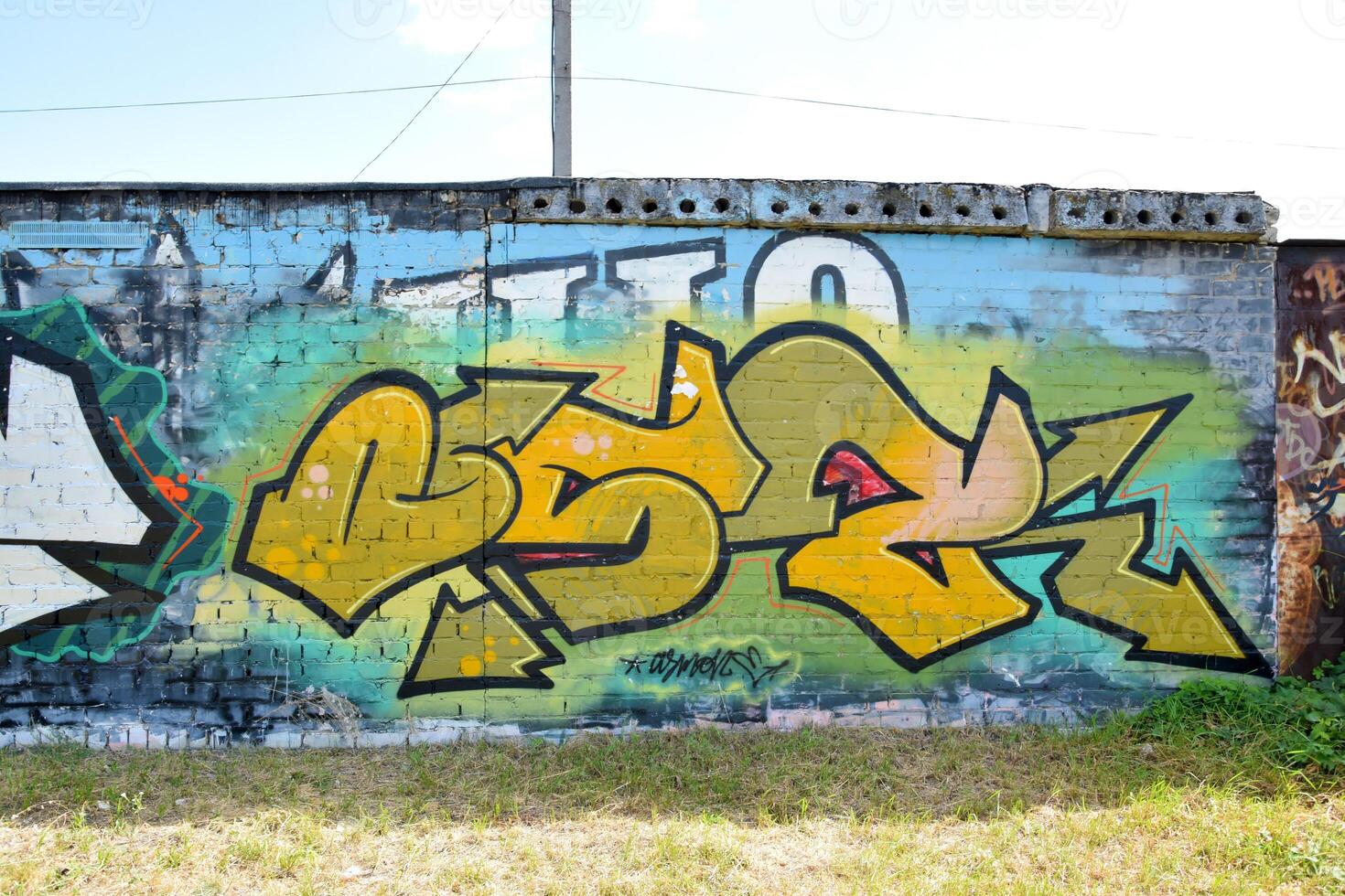 Colorful background of graffiti painting artwork with bright aerosol outlines on wall. Old school street art piece made with aerosol spray paint cans. Contemporary youth culture photo