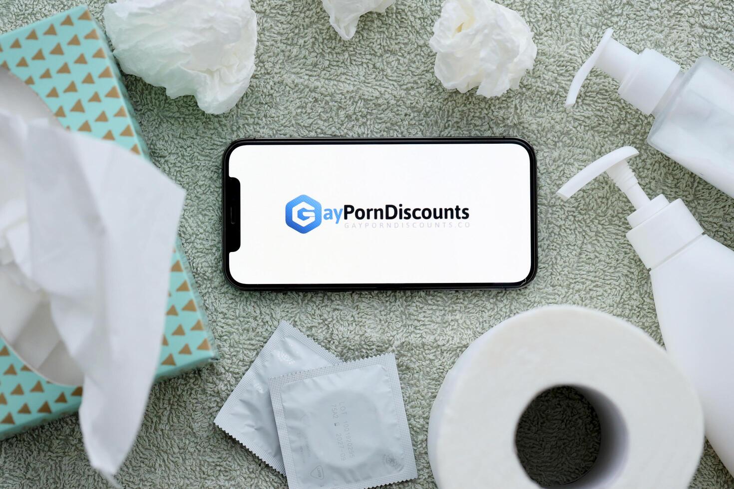 KYIV, UKRAINE - JANUARY 23, 2024 GayPornDiscounts adult content website logo on display of iPhone 12 Pro photo