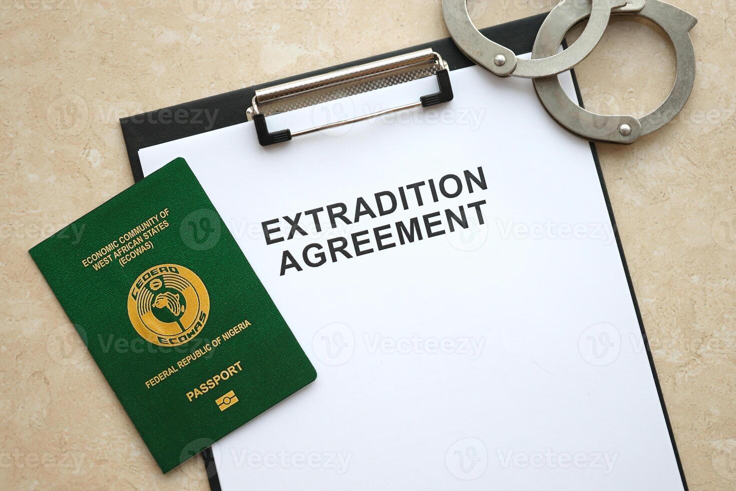 Passport of Pakistan and Extradition Agreement with handcuffs on table photo