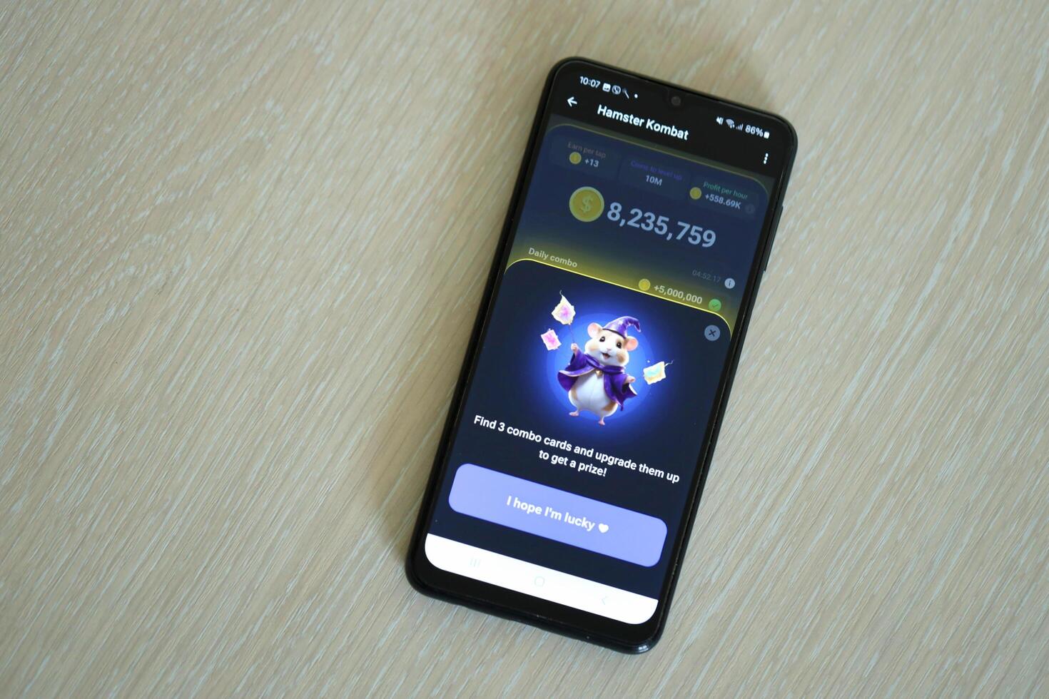 KYIV, UKRAINE - APRIL 20, 2024 Hamster Kombat telegram bot on smartphone screen. Hamster Kombat is a viral Telegram crypto game for earn HMSTR tokens by managing virtual crypto exchange photo