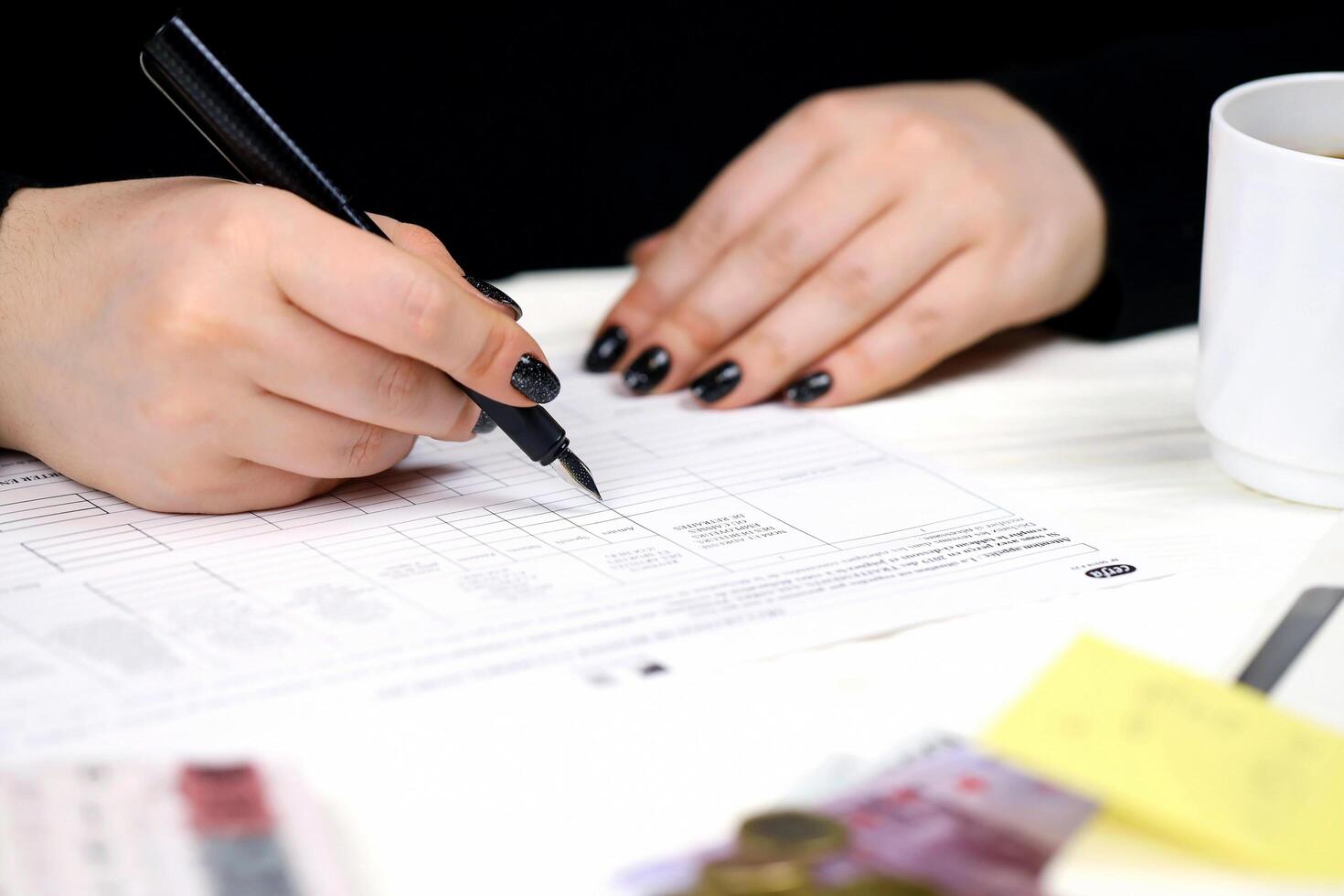 KYIV, UKRAINE - OCTOBER 31, 2023 Accountant fill french tax form 2041E Withholding tax declaration in end of tax period. Taxation and paperwork routine photo