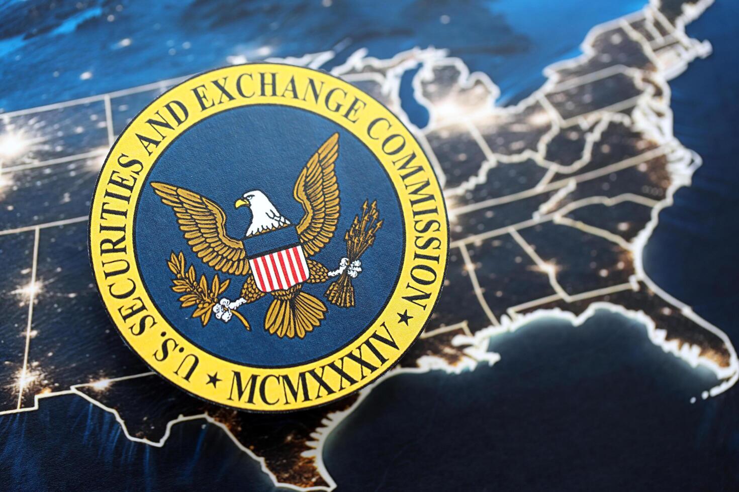 KYIV, UKRAINE - JUNE 26, 2024 U.S. Securities and Exchange Commission coat of arms on paper map of United States photo