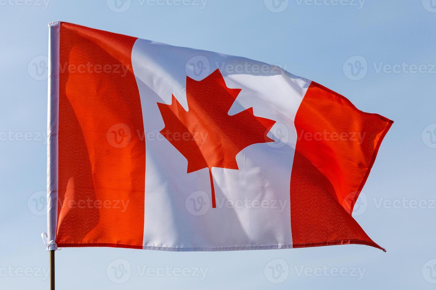 Beautiful Canada flag and blue sky photo