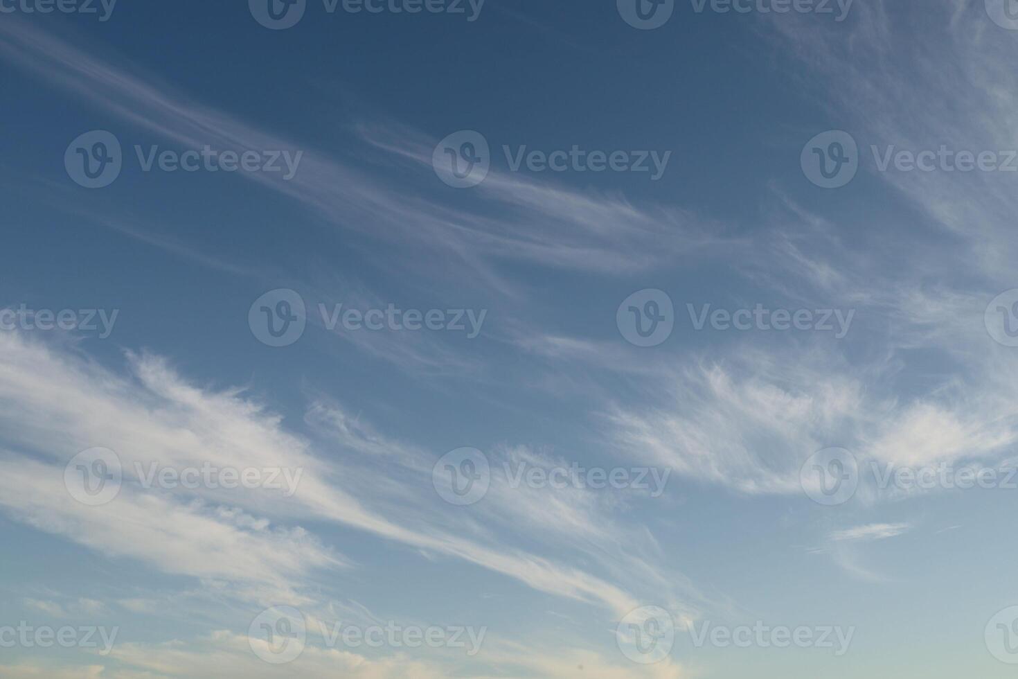 Thin transparent clouds on a blue sky photo