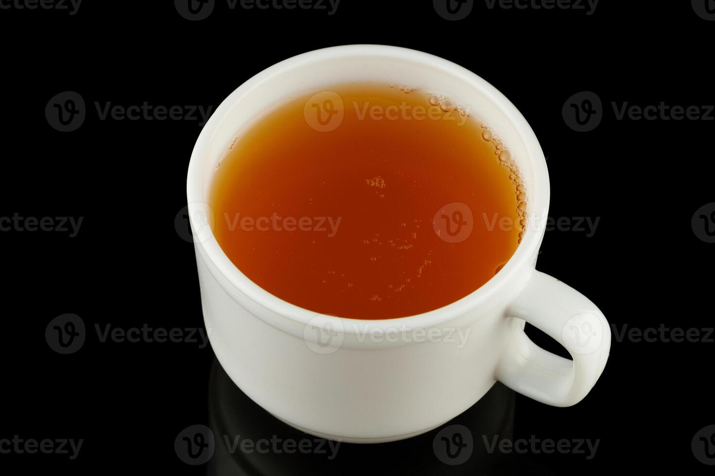 Green tea in a cup on a black background photo