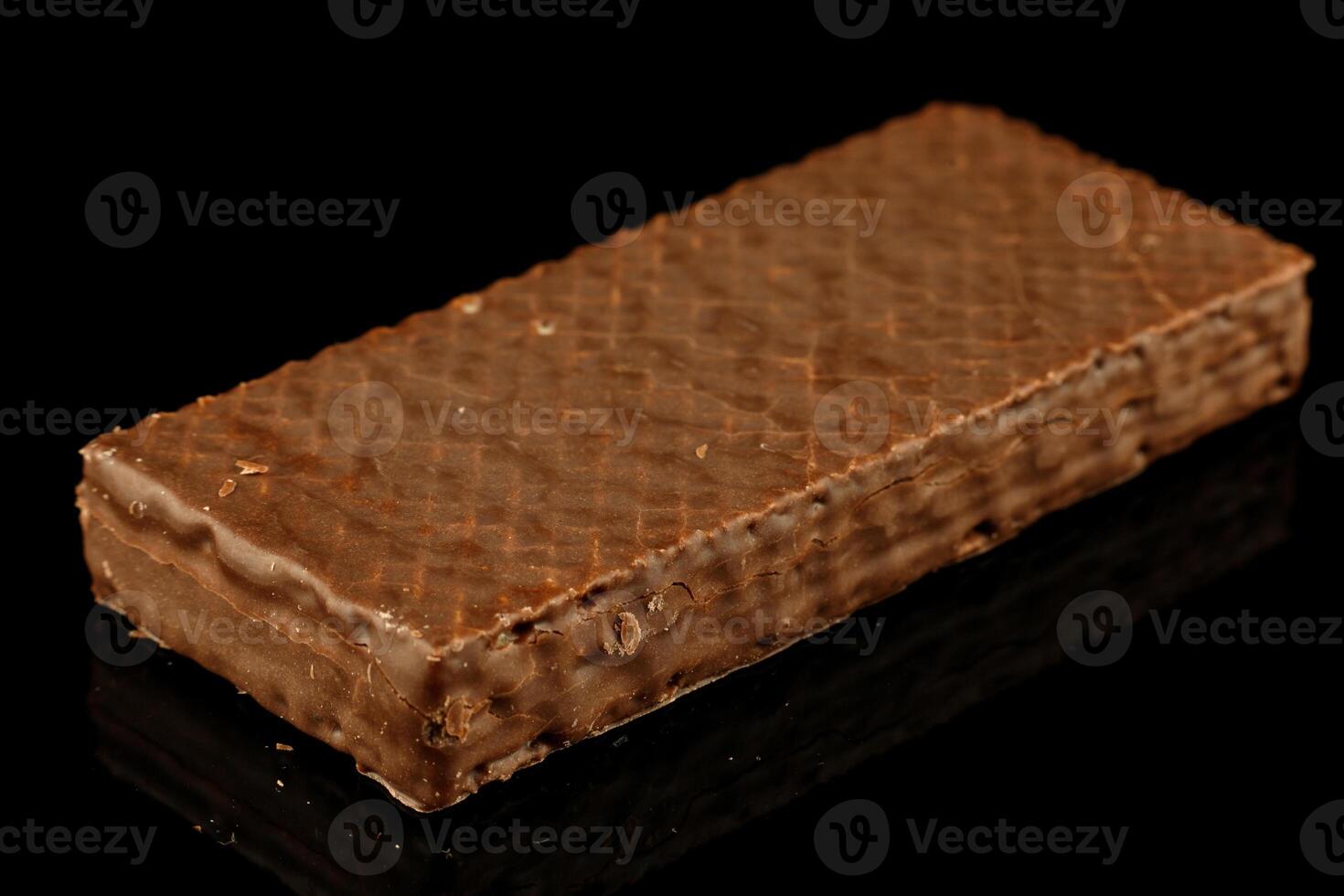 Waffle candies in chocolate black background photo
