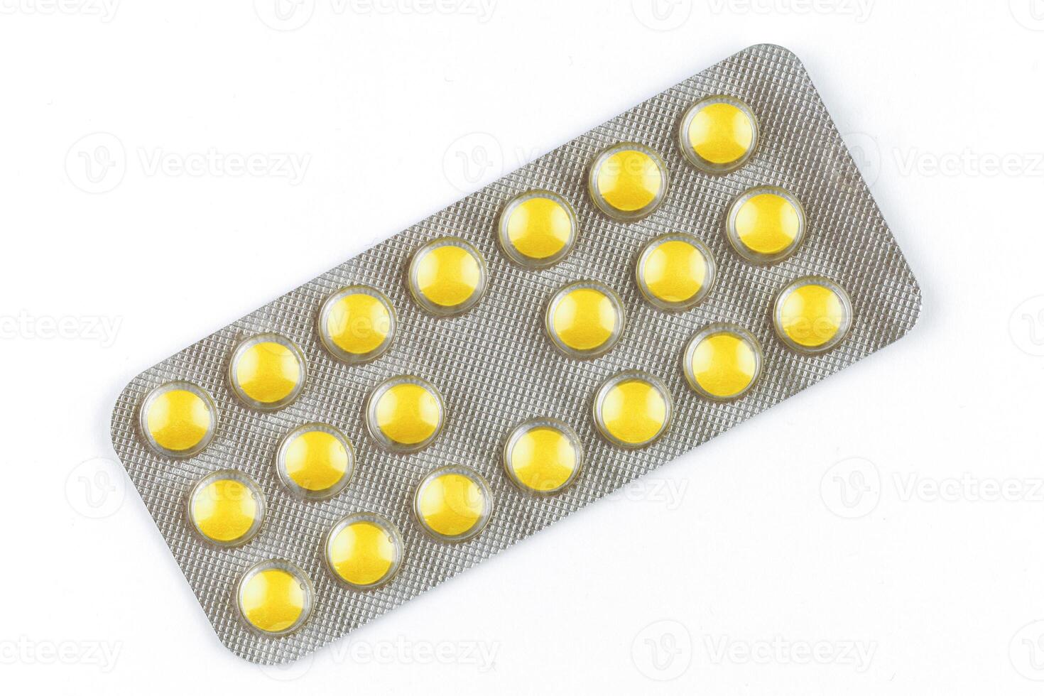 Yellow pills in a transparent blister photo